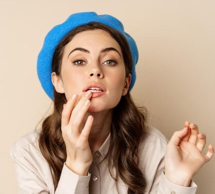 A person with long hair wearing a blue hat
AI-generated content may be incorrect.