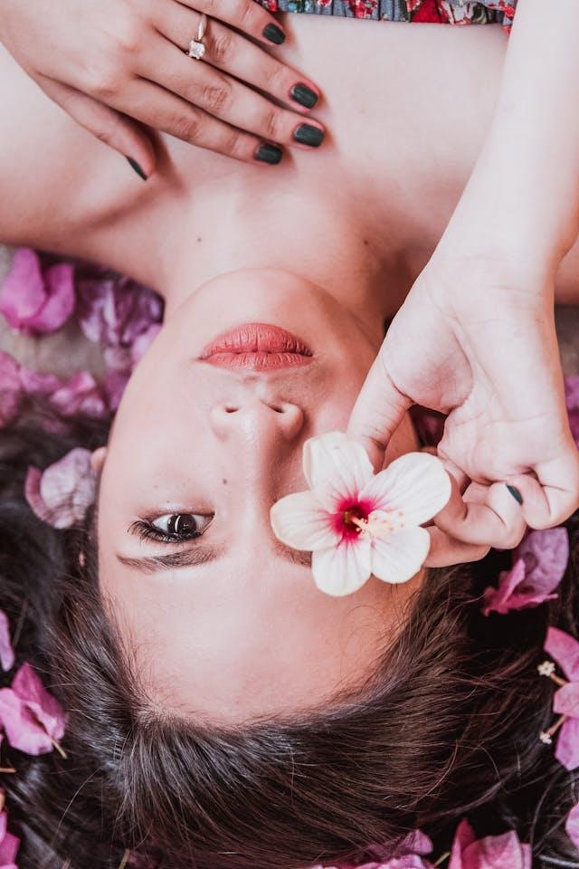 A person lying down with a flower in her mouth
AI-generated content may be incorrect.
